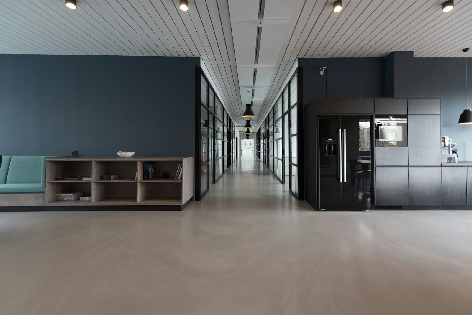 A quiet, light-filled corridor in a completed Norr Atelier project